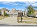 Beautiful stone-faced home featuring a two-car garage and well-maintained lawn, complemented by a mailbox at 14920 High Bluff Ct, Charlotte, NC 28278