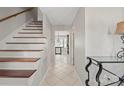 Inviting hallway with staircase and tile flooring, leading to various rooms in the home at 16417 Grapperhall Dr, Huntersville, NC 28078