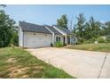 Attractive single-story home with attached garage and a long drive, surrounded by lush trees at 1700 Ivey Ct, Maiden, NC 28650