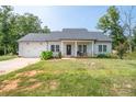Inviting single-story home with attached garage, manicured lawn, and a welcoming front porch area at 1700 Ivey Ct, Maiden, NC 28650