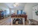 Comfortable living room featuring leather furniture, wood-look floors, and ample natural light at 1700 Ivey Ct, Maiden, NC 28650