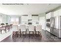 Modern kitchen featuring white cabinetry, stainless steel appliances, and an island with bar seating at 2009 Nettle Bank Rd # 3292, Indian Trail, NC 28079