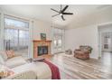 Bright living room boasts a brick fireplace, neutral walls, high ceiling, and wood-look flooring at 201 Remally Ln, Huntersville, NC 28078