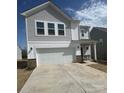 Charming two-story home boasts a two-car garage, neat landscaping, and neutral siding at 202 Brentwood Dr, Statesville, NC 28625