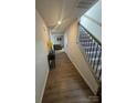 Bright hallway features hardwood floors, a staircase with carpeted steps and wood trim at 202 Brentwood Dr, Statesville, NC 28625