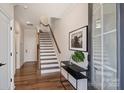 Open entryway with hardwood floors, staircase, and modern decor at 208 Emerson Ave, Charlotte, NC 28204