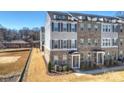 Exterior view of townhomes with gray siding and rooftop decks at 208 Emerson Ave, Charlotte, NC 28204