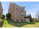 Expansive backyard showcasing a multi-level deck and brick exterior of the home at 2251 Barrowcliffe Nw Dr, Concord, NC 28027