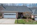 Inviting brick home featuring an attached garage, well-kept lawn, and charming front door decor at 3131 9Th Street Ne Dr # 31, Hickory, NC 28601