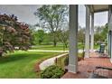 Inviting porch view showcasing the expansive front yard and picturesque landscaping at 3400 Tracelake Dr, Matthews, NC 28105