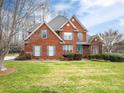 Charming two-story red brick home with manicured lawn and lush landscaping at 3516 Araglin Dr, Gastonia, NC 28056