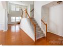 Bright foyer with hardwood floors and stairway leading upstairs at 4036 Sawmill Trace Dr, Charlotte, NC 28213