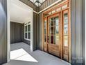 A grand entrance with a stained wood front door and covered porch at 4262 Brandy Creek Ct, Clover, SC 29710
