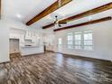 Open-concept living area with wood beam ceilings and kitchen with modern appliances at 4262 Brandy Creek Ct, Clover, SC 29710