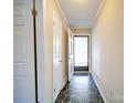 An inviting entryway with tile floors and a view of the front porch through the storm door at 4401 Coachwood Ln, Gastonia, NC 28056