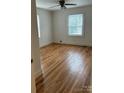Bright bedroom featuring gleaming hardwood floors, neutral walls, and natural light from the windows at 501 Franklin Ave, Shelby, NC 28150