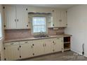 Cozy kitchen featuring ample cabinet space, laminate countertops, and a stainless steel sink at 501 Franklin Ave, Shelby, NC 28150
