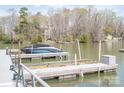 Boat at the dock featuring a modern design and located on a calm lake at 7343 Rock Island Rd, Charlotte, NC 28278