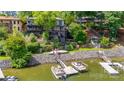 Stunning waterfront home featuring a private dock, boat lift, multiple decks, and beautifully landscaped grounds at 8014 Kiwi Pt, Tega Cay, SC 29708