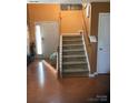 Inviting entryway showcasing a staircase with wood railings and hardwood floors, leading to the upper level at 806 Dale Ave, Charlotte, NC 28216