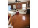 Spacious living room featuring a fireplace, neutral walls, hardwood floors, and bright, natural light at 806 Dale Ave, Charlotte, NC 28216