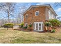 A view of the rear exterior of a brick home highlighting its fenced yard and access to a refreshing pool at 809 E 23Rd Street St, Newton, NC 28658
