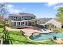 Large backyard with a swimming pool, landscaped patio, and an inviting covered outdoor space at 8511 Fox Tail Ln, Huntersville, NC 28078