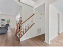 Bright, modern staircase featuring wood steps, white risers and a wood handrail at 8511 Fox Tail Ln, Huntersville, NC 28078