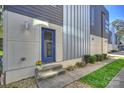Modern home exterior featuring a vibrant blue door, stone walkway, and manicured landscaping at 914 Greenleaf Ave # A, Charlotte, NC 28202