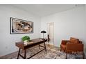 Modern office with wood desk, leather chair and an abstract art providing a professional setting at 914 Greenleaf Ave # A, Charlotte, NC 28202