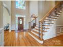 Grand foyer with hardwood floors, a staircase with iron spindles, and a large window at 928 Thorn Ridge Ln, Clover, SC 29710