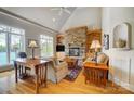 Cozy living room with stone fireplace, built-in shelving, and hardwood floors at 928 Thorn Ridge Ln, Clover, SC 29710