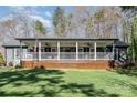 Charming home with a covered front porch, complete with rocking chairs and an American flag at 9401 Elvis Dr, Charlotte, NC 28215