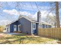 Backyard featuring newly constructed fence and patio with chimney at 9930 Sardis Oaks Rd, Charlotte, NC 28270