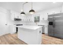 Bright kitchen with stainless steel appliances, island, and white cabinetry at 9930 Sardis Oaks Rd, Charlotte, NC 28270