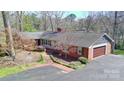 Aerial view of a brick home with mature landscaping and a driveway leading to the attached garage at 101 Woodvale Cir, Lincolnton, NC 28092