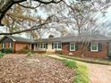 Traditional brick home featuring black shutters, a brick walkway, and professional landscaping at 101 Woodvale Cir, Lincolnton, NC 28092