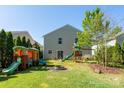 Spacious backyard features a playhouse, playset, fire pit, and plenty of room for outdoor activities at 12915 Settlers Trail Ct, Charlotte, NC 28278