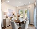 Bright dining room with a round wooden table, comfortable seating, and large windows at 1305 31St Ne St, Conover, NC 28613