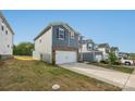 Features a two-car garage, landscaped front yard, and views of neighboring properties under a clear blue sky at 1305 31St Ne St, Conover, NC 28613