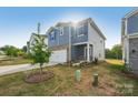 Home with blue siding, brick accents, a two-car garage, and a well-manicured front yard at 1305 31St Ne St, Conover, NC 28613