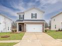 Charming two-story home with brick accents, a two-car garage, and a concrete driveway at 1466 31St Ne St, Conover, NC 28613