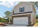 Charming two-story home featuring a two-car garage, brick accents, and blue shutters at 1466 31St Ne St, Conover, NC 28613