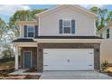 Charming two-story home featuring a two-car garage, brick accents, and blue shutters at 1466 31St Ne St, Conover, NC 28613