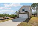 Charming two-story home featuring a two-car garage, brick accents, and blue shutters at 1466 31St Ne St, Conover, NC 28613