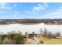 Expansive aerial view of home on the water featuring mature trees and a long driveway at 225 Kirkpatrick Rd, Taylorsville, NC 28681