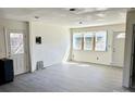 Spacious living room with light-colored wood flooring, new windows offering abundant natural light, and white trim at 2546 Amber Crest Dr, Gastonia, NC 28052