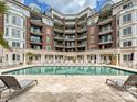 Beautiful pool with lounge chairs and a stone tile deck in front of luxury apartments at 300 W 5Th St # 402, Charlotte, NC 28202