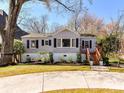 Charming home with a manicured front yard, brick facade, and inviting wooden stairs to the front door at 3016 Hanson Dr, Charlotte, NC 28207