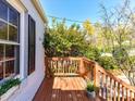 Cozy front porch featuring wooden flooring, railing, and views of the surrounding greenery at 3016 Hanson Dr, Charlotte, NC 28207